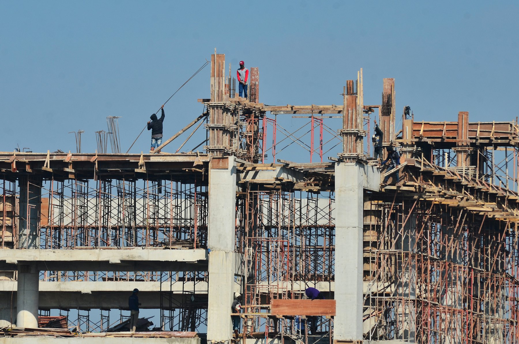A concrete frame under construction, with formwork and props on each floor